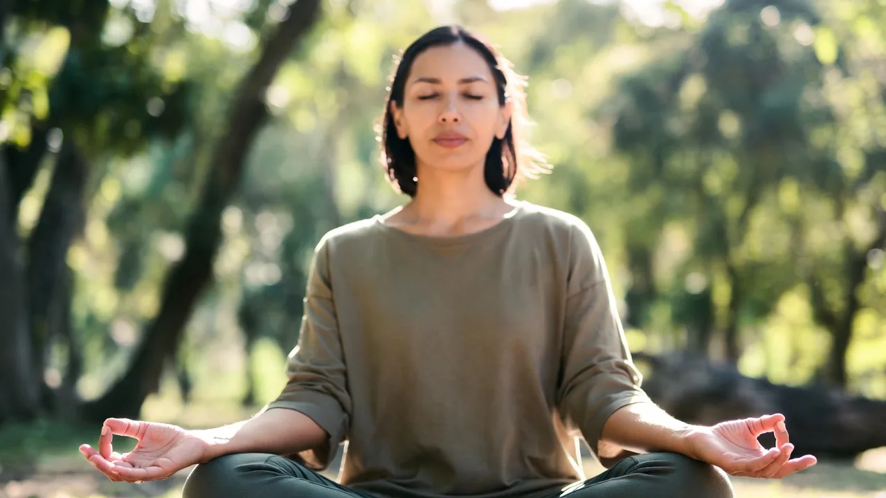 Person practicing relaxation and deep breathing to reduce stress and calm the mind
