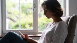 Woman holding a pregnancy test at five weeks pregnant.